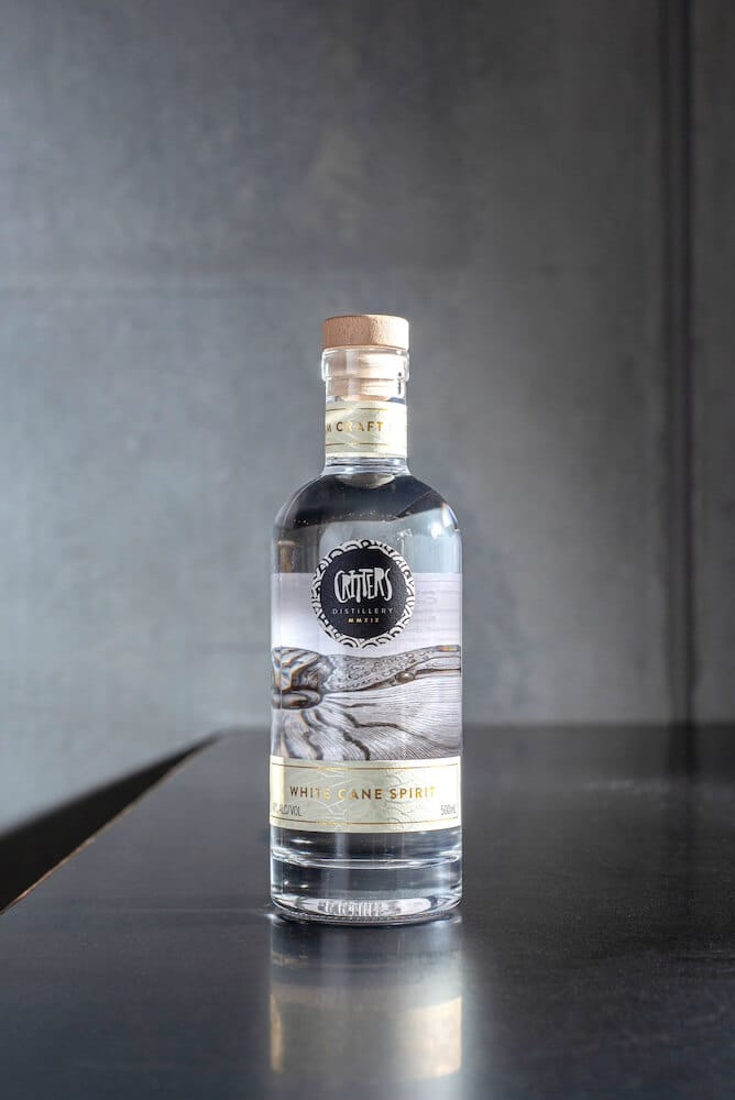 Critters Distillery White Cane Spirit front on bench Critters Distillery White Cane Spirit front on bench